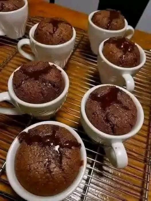 Fudgy 30g protein chocolate brownie mug cake in a white mug, topped with Greek yogurt and chocolate chips.