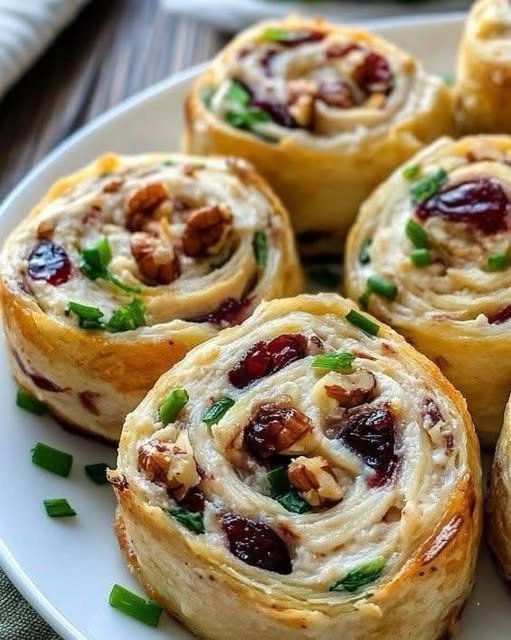 Cranberry Walnut Pinwheels with golden flaky puff pastry, creamy cheese filling, dried cranberries, and crunchy walnuts. Copy