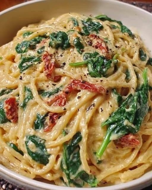 Spinach Tomato Pasta with baby spinach, sun-dried tomatoes, creamy Parmesan sauce, garlic, and tender pasta
