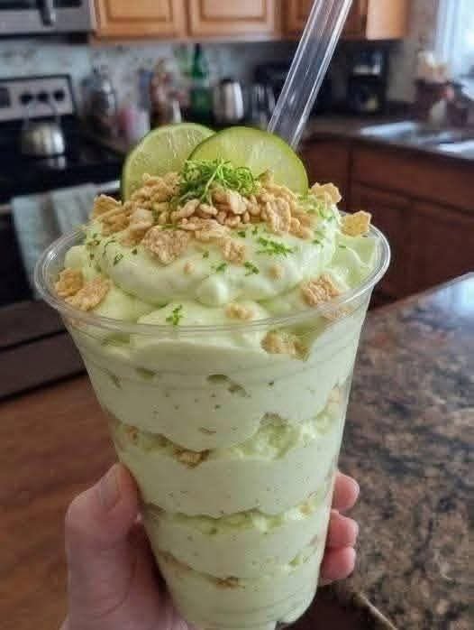 Key Lime Fluff with creamy lime filling, fresh lime slices, lime zest, and crunchy nut topping